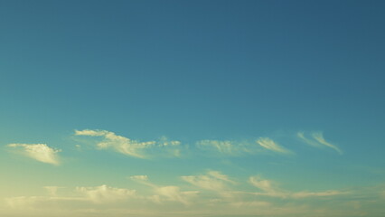 Fototapeta premium A Serene Blue Sky adorned with Whimsical Clouds for a breathtaking view of tranquility