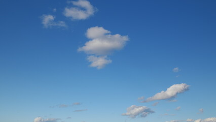 A Beautiful, Serene Blue Sky Filled with Soft, Fluffy Clouds, Indicating a Fantastic Day Ahead © beholdereye