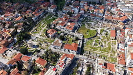 Naklejka premium Aerial drone portrait photo of ancient Roman Market featuring tower of Winds and Gate of Athena in the heart of Athens historic centre built in Plaka district, below Acropolis hill, Attica, Greece