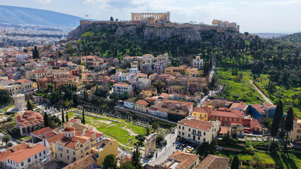 Naklejka premium Aerial drone portrait photo of ancient Roman Market featuring tower of Winds and Gate of Athena in the heart of Athens historic centre built in Plaka district, below Acropolis hill, Attica, Greece