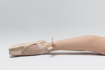 Ballet dancer showing a pointed toe on the floor with a soft background during a practice session...