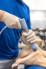 Physiotherapist performs ultrasound therapy on female patient knee. Joint rehabilitation.