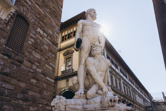 Hercules and Cacus sculpture by Baccio Bandinelli standing in Piazza della Signoria, Florence, Italy, with bright sunlight