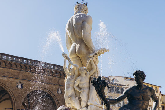 Neptune fountain in Florence, Italy, details of the marble sculpture, water splashing around the mythological god