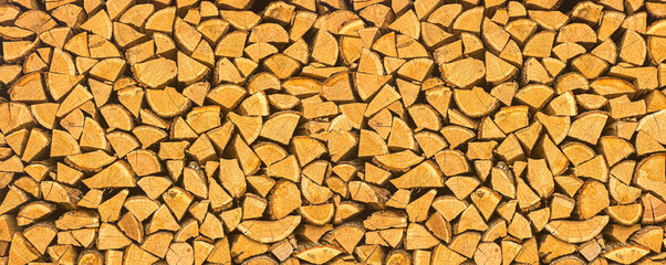 Naklejka premium Wood logs neatly stacked for winter heating fuel