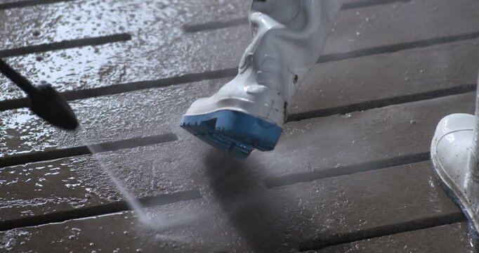 Washing work boots with power hose water jet spray farm factory hygiene safety bio security