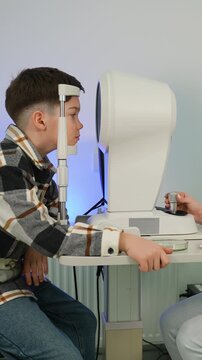Young boy undergoing eye examination at ophthalmologist's office