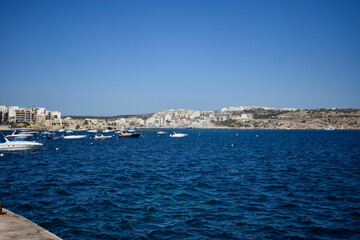 Fototapeta premium Boats Floating on the Blue Sea Near the Coastline of Malta