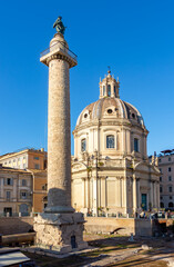 Obraz premium Trajan's Column and Church of the Most Holy Name of Mary at Trajan Forum in Rome, Italy