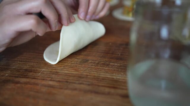 Person preparing traditional argentinian empanadas with vegetable filling