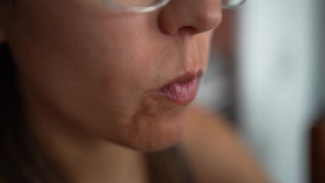 Close-up of a young woman eating an empanada
