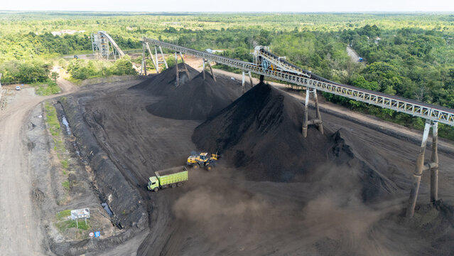 Drone footage from a coal mining site in South Kalimantan shows trucks and heavy equipment in action