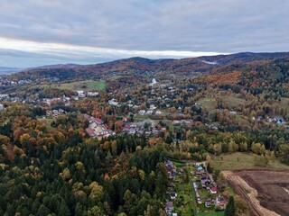 Obraz premium rolling moody hills meet city outskirts, dramatic elevated terrain with village and city views