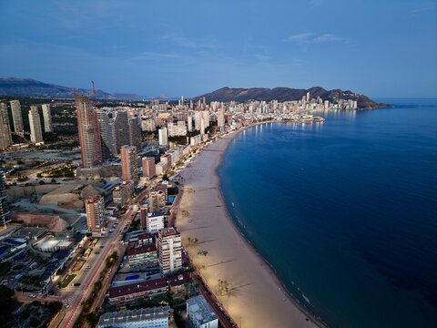 nightlife by shore, twilight drapes waterfront as lively streets pulse with energy and color