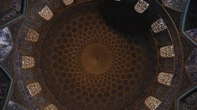 Low angle view of the dome of Sheikh Lotfollah Mosque in Isfahan, Iran, showing detailed Persian tile patterns and Islamic architecture. Famous historic mosque located on Naqsh e Jahan Square
