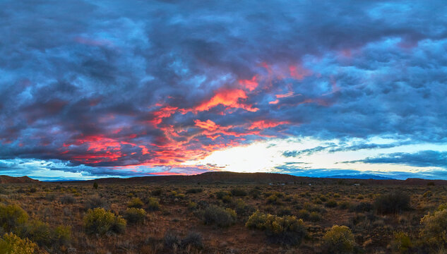 Panorama Vibrant Sunset Pink Clouds Over Desert Landscape in American Southwest