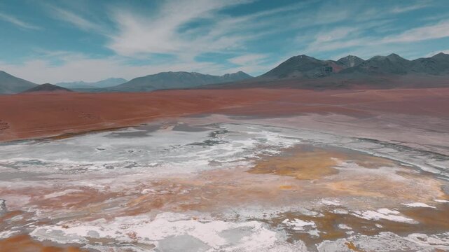 Aerial view of a salt lake in the Bolivian Altiplano, with pale mineral water and reflective surface. Minimalist landscape with soft tones and remote atmosphere.