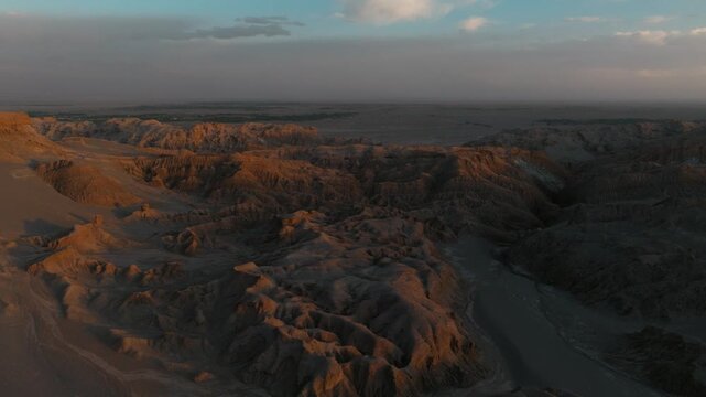 Drone view of rugged desert mountains and dry valleys in northern Chile. Erosion has sculpted dramatic patterns across the arid landscape.