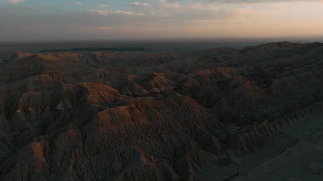 Drone view of rugged desert mountains and dry valleys in northern Chile. Erosion has sculpted dramatic patterns across the arid landscape.