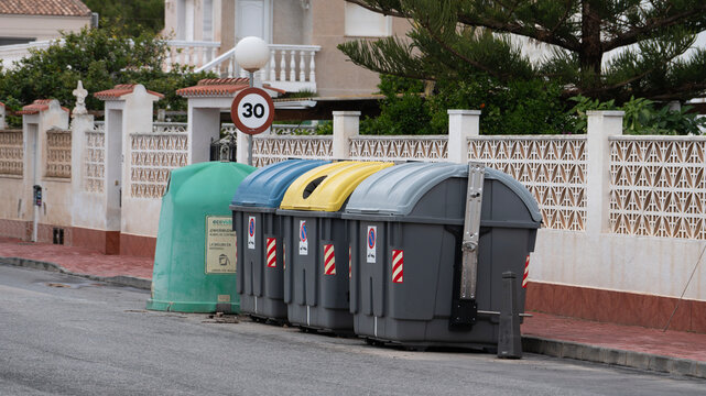 Recycling and waste containers on residential street for sorting