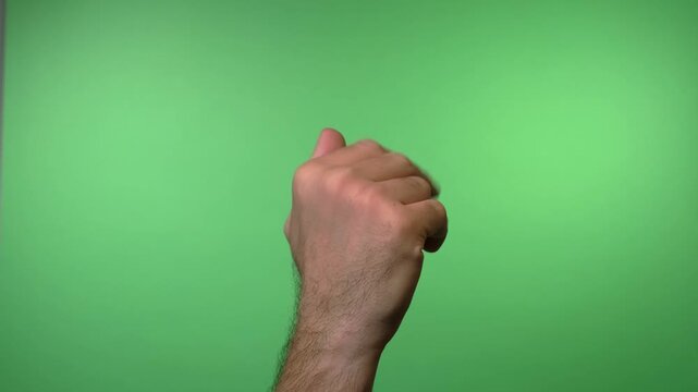 Close up video of a hand using first two fingers to gesture "come here" against a solid green background for compositing.