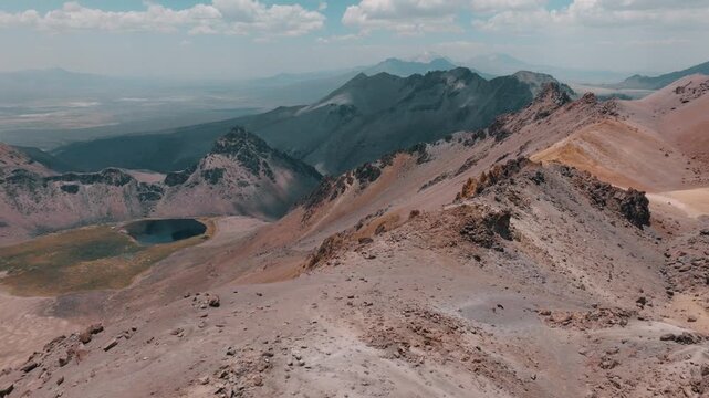 Aerial view of volcanic peaks, alpine lakes and rugged terrain in Sajama National Park, Bolivia. A remote high-altitude landscape in the Andes.