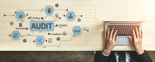 A professional workspace featuring hands typing on a laptop surrounded by visual elements...