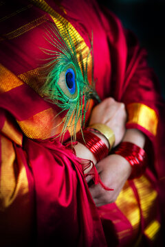 Woman is red sari with red bangles 