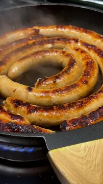 Baking chicken sausage in pan at home, chipolata
