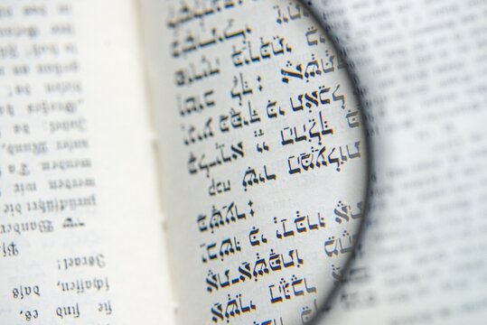 Magnifying Glass Over Hebrew Text and German Schwabach Script