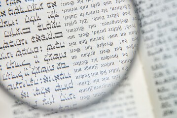 Fototapeta premium Magnifying Glass Over Hebrew Text and German Schwabach Script
