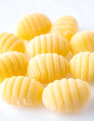A close-up of several small, ridged, yellow objects on a white surface