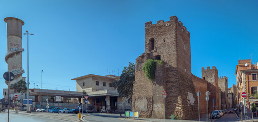 Rome, Italy: Ancient Roman wall and tower with modern buildings