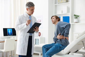 Man having appointment with urologist on medical couch in clinic