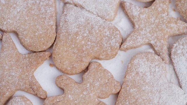 Cookies with festive decor, Dessert platter featuring handcrafted biscuits for special occasions, Warm brown cookies dusted with sugar presented in cozy rustic kitchen setting
