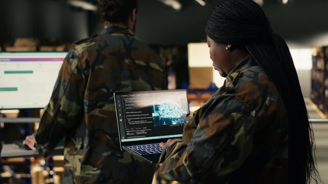 Black soldier leveraging artificial intelligence and cloud computing, warehouse management for defense logistics. Woman reviewing AI software interface with neural networks for security.