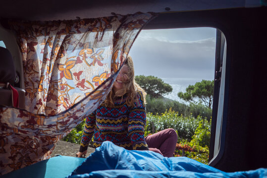 Nerano, Campania, Italy: Vanlife Woman smiling in camper van with ocean view