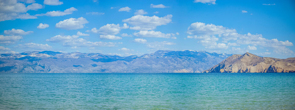 Prvić Island and mountains seen from Ba&scaron;ka, Krk Island, Croatia, Turquoise sea and mountains under blue sky
