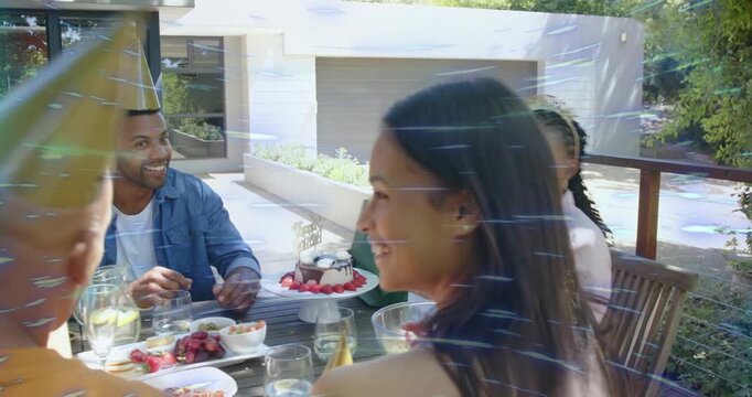 Birthday celebrant receiving green gift bag, opening and thanking friends near cake during party