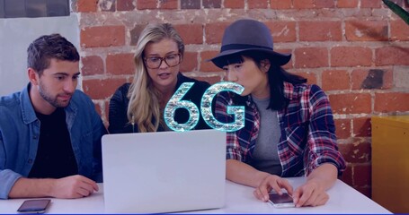 Collaborating three colleagues leaning toward silver laptop at office, with 6G graphic and hat