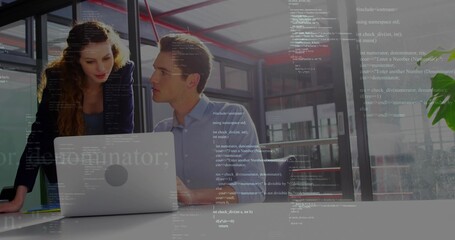 Working colleagues in blazer, blue shirt reviewing code on silver laptop at white table in office
