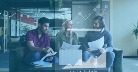 Discussing coworkers in red shirt, blazer, reviewing documents in office lounge, laptop, tablet