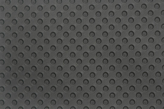 Black rubber sheet pattern background with circular holes. Industrial concept. For graphic design, 3D rendering and banners