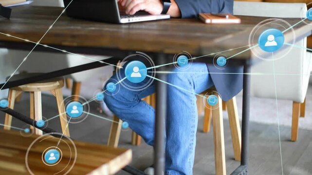 Senior exec typing on laptop while pulsing blue node starting network growth showing connectivity