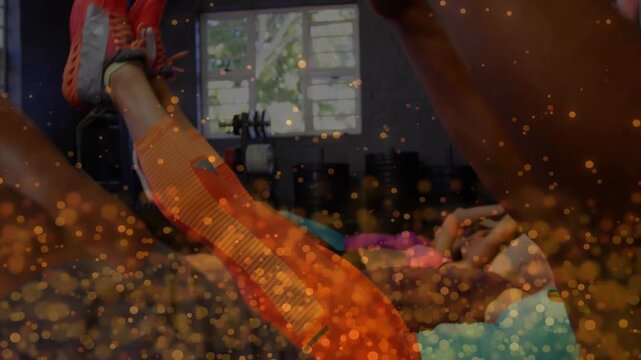 Gym class following cue, performing V-sit raises for core on mats, golden particles covering frames