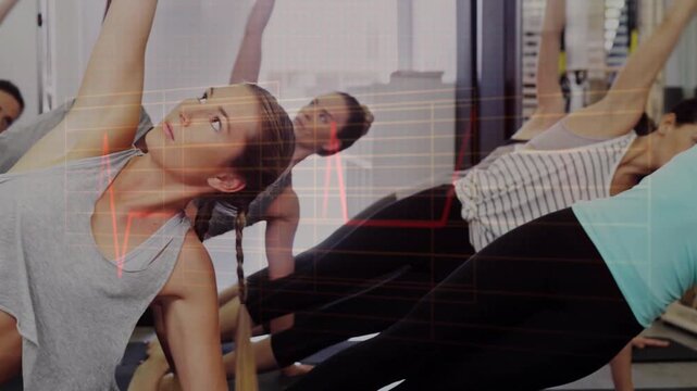 Fitness lead shifting into side plank on cue, lifting med for core, heartbeat grid overlaying group