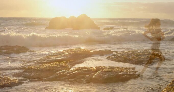 Woman walking rocks, sun backlight revealing then fading silhouette, making marketing visuals