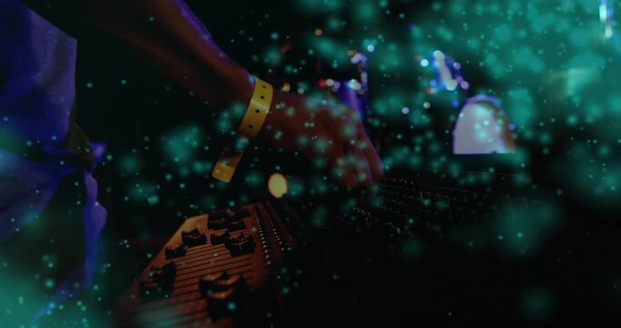 Male DJ twisting knobs, sliding faders for live set, resting, teal overlay drifting across console