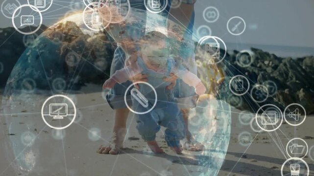 Adult nudging baby guiding steps to practice walking on beach, tech globe of icons growing around