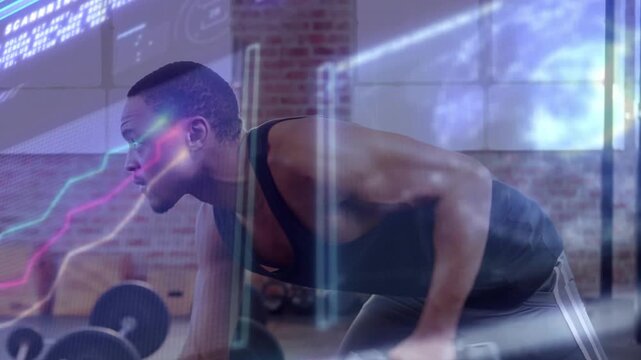 Rowing athletic man bracing and pulling single-arm dumbbell at gym, wearing dark training clothes